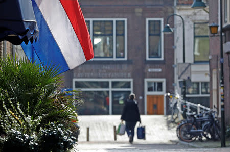 A woman walks past the center of the city of Delft, Netherlands March 14, 2017. REUTERS/Yves Herman