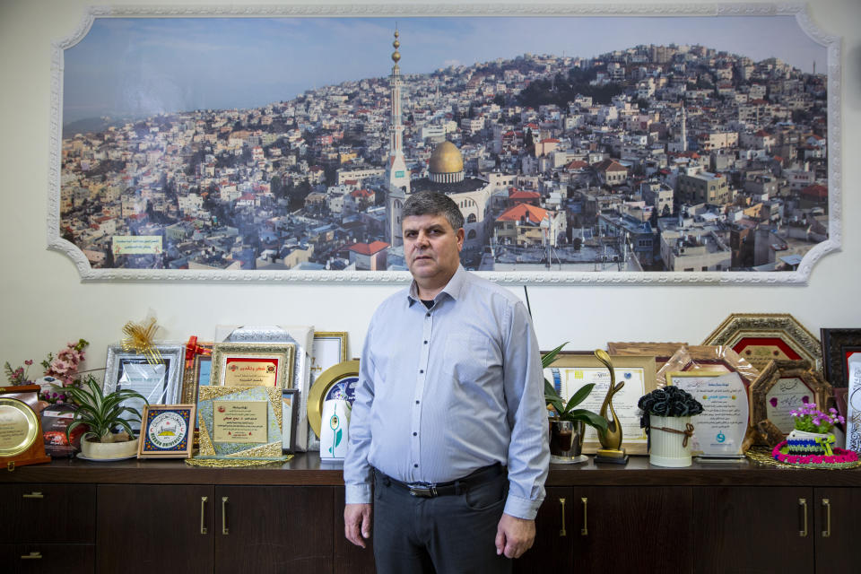 In this Tuesday, Feb. 4, 2020, photo, Samir Sobhi Mahamed, Mayor of the Israeli Arab town Umm al-Fahm, poses for a photo at the his office in Umm al-Fahm. President Donald Trump's Mideast initiative suggests that the densely populated Arab region of Israel could be added to a future Palestinian state, if both sides agree. The proposal has infuriated many of Israel's Arab citizens, who view it as a form of forced transfer. (AP Photo/Oded Balilty)