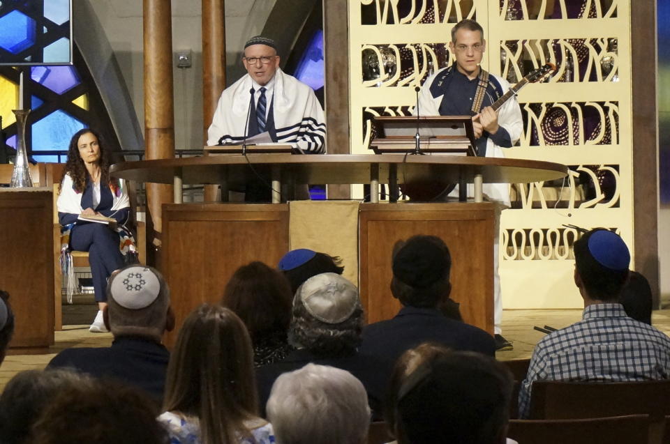 Senior Rabbi Gayle Pomerantz (seated, left), Rabbi Robert Davis and Cantor Juval Porat lead Shabbat services at Temple Beth Sholom in Miami Beach, Fla., on Friday, Oct. 13, 2023. The rabbis spoke to the congregation's shock, fear and anger after Hamas's brutal attack, and urged the faithful to turn those emotions into solidarity and support for Israel, the hostages, and peace. (AP Photo/Giovanna Dell'Orto)