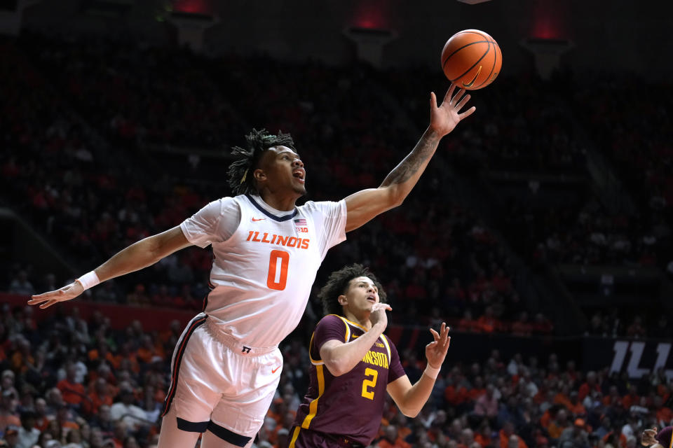 Illinois' Terrence Shannon Jr. drives to the basket past Minnesota's Mike Mitchell Jr. during the first half of an NCAA college basketball game Wednesday, Feb. 28, 2024, in Champaign, Ill. (AP Photo/Charles Rex Arbogast)