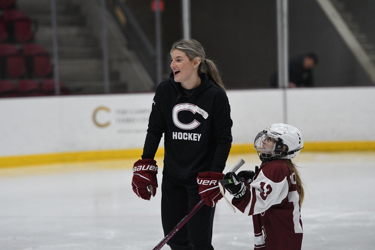 Colgate University women's ice hockey team Captain Danielle Serdachny skates with a Rising Raider during on-ice skills training on Jan. 2, 2024. Rising Raiders is a mentoring program for local girls who play ice hockey that Serdachny co-founded at Colgate.