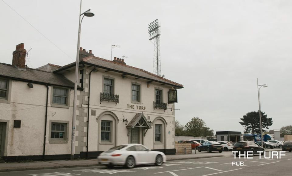 photo from the road of The Turf pub outside The Racecourse Ground