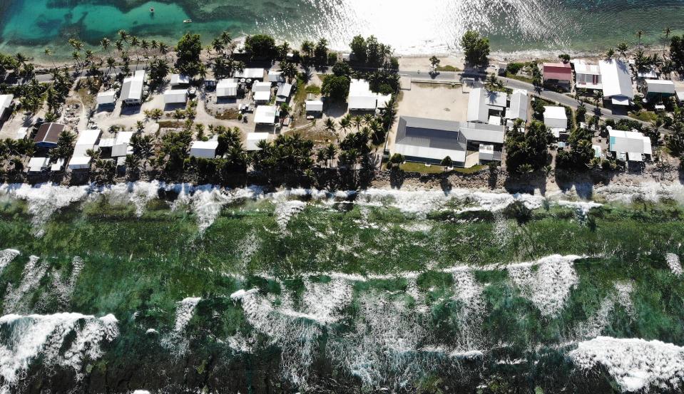 An aerial view of a strip of land between the Pacific Ocean (BOTTOM) and lagoon on November 27, 2019 in Funafuti, Tuvalu.