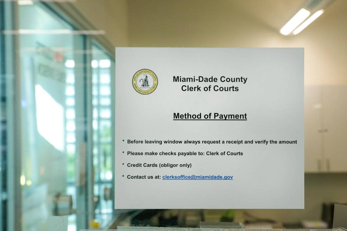 A sign with information regarding on how to pay court fees its taped to a glass window at the Miami-Dade County Clerk of Court office inside the children’s courthouse in downtown Miami on Monday, February 13, 2023.