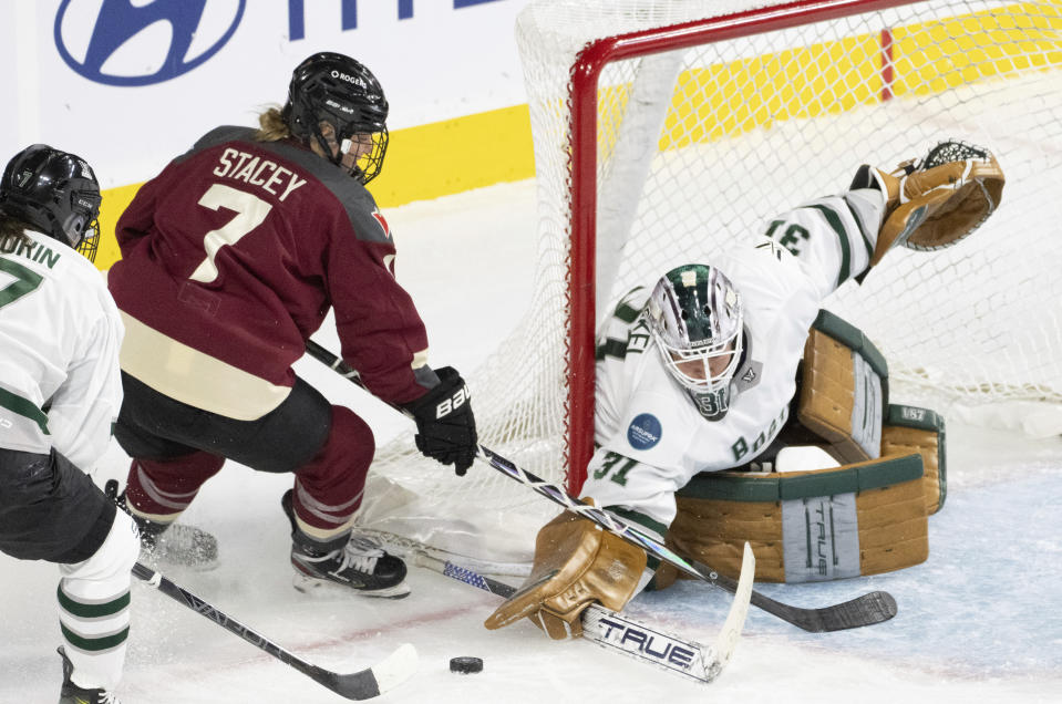 Boston goaltender Aerin Frankel (31) makes a save against Montreal's Laura Stacey (7) during the third period of Game 1 of a PWHL hockey playoff series Thursday, May 9, 2024, in Montreal. (Christinne Muschi/The Canadian Press via AP)