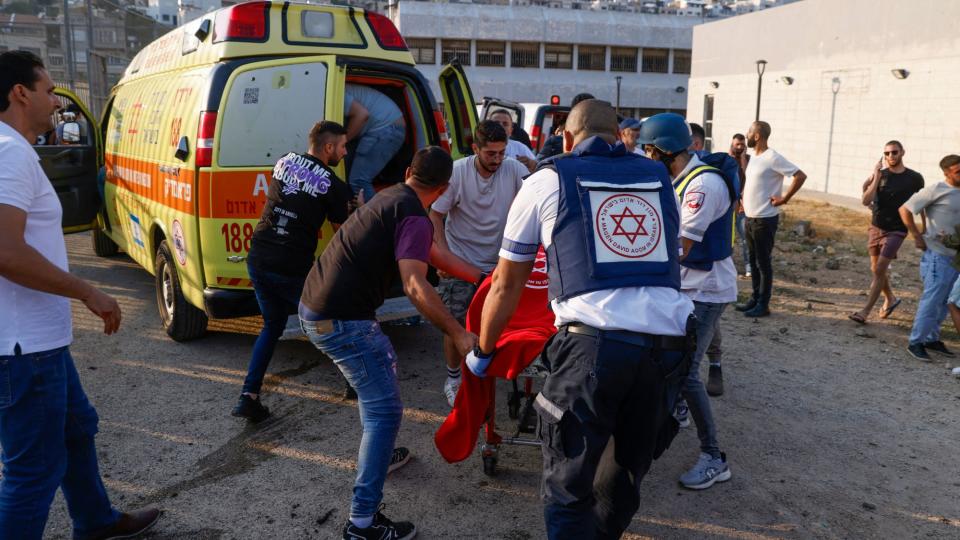  Israeli security forces and medics respond to a strike in Majdal Shams village . 