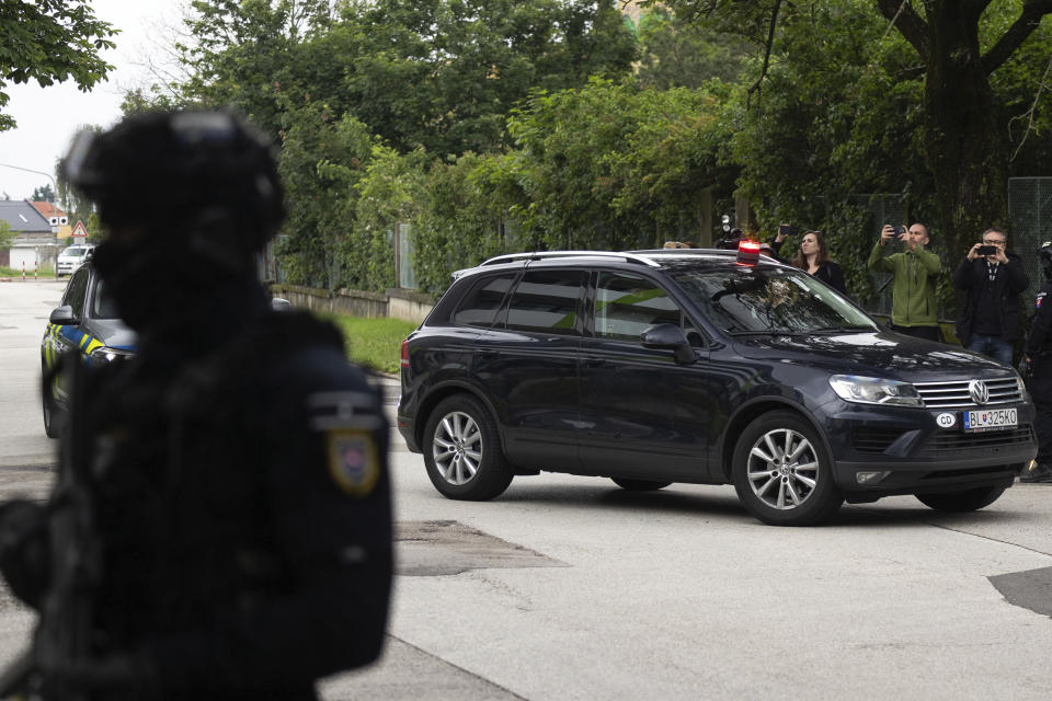 Policemen guard the area as convoy brings the suspect, in shooting of Slovakia's Prime Minister Robert Fico, to court in Pezinok, Slovakia, Saturday, May 18, 2024. Officials in Slovakia say Prime Minister Robert Fico has undergone another operation two days after his assassination attempt and remains in serious condition. (AP Photo/Tomas Benedikovic)