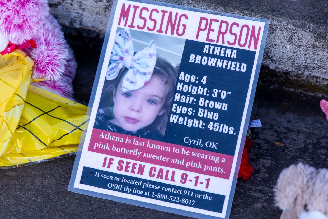 A missing person poster along with flowers and teddy bears are placed on the porch of  Athena Brownfield's home in Cyril on Jan. 19, 2023.