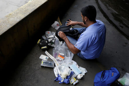 A volunteer puts medical supplies in his backpack as he gets ready for help injured demonstrators in Caracas, Venezuela April 22, 2017. REUTERS/Marco Bello