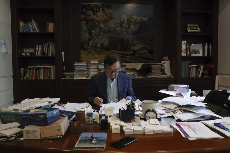 In this Aug. 20, 2019, photo, Huawei's founder Ren Zhengfei reads documents in his office at the Huawei campus in Shenzhen in Southern China's Guangdong province. Ren says its troubles with President Donald Trump are hardly the biggest crisis he has faced while working his way from rural poverty to the helm of China’s first global tech brand. (AP Photo/Ng Han Guan)