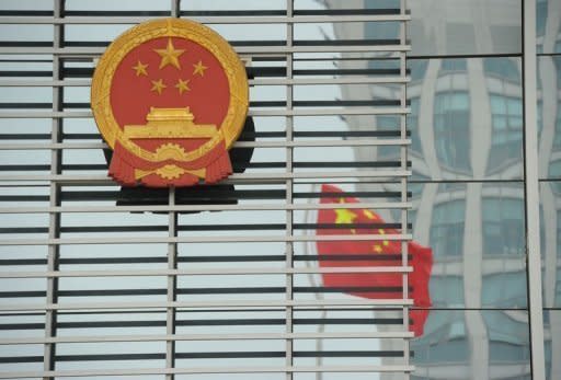 China's National Emblem and a reflection of the national flag outside the courthouse in Hefei. Gu Kailai -- the wife of disgraced Chinese politician Bo Xilai -- did not deny murdering a British man during her one-day trial that ended with no verdict in Hefei