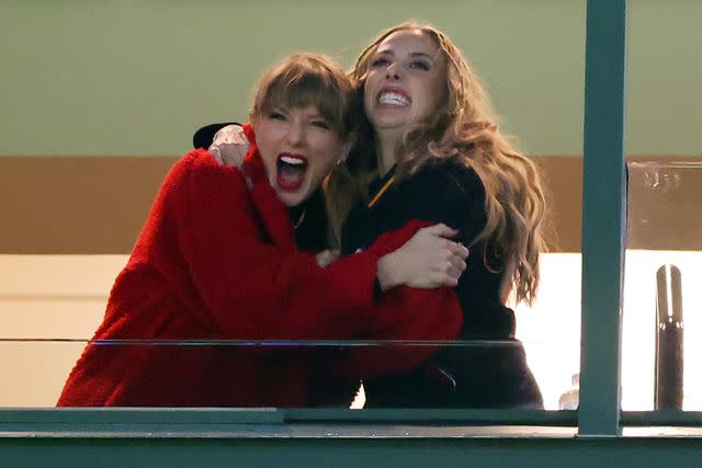 <p>Stacy Revere/Getty Images</p> Taylor Swift and Brittany Mahomes hug at the Chiefs-Packers game on Dec. 3, 2023.