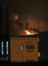 Smoke and flames rise from an alleged weapons storage depot at a Shiite Huthi rebel camp after an airstrike by the Saudi-led alliance on March 30, 2015 in the Yemeni capital Sanaa