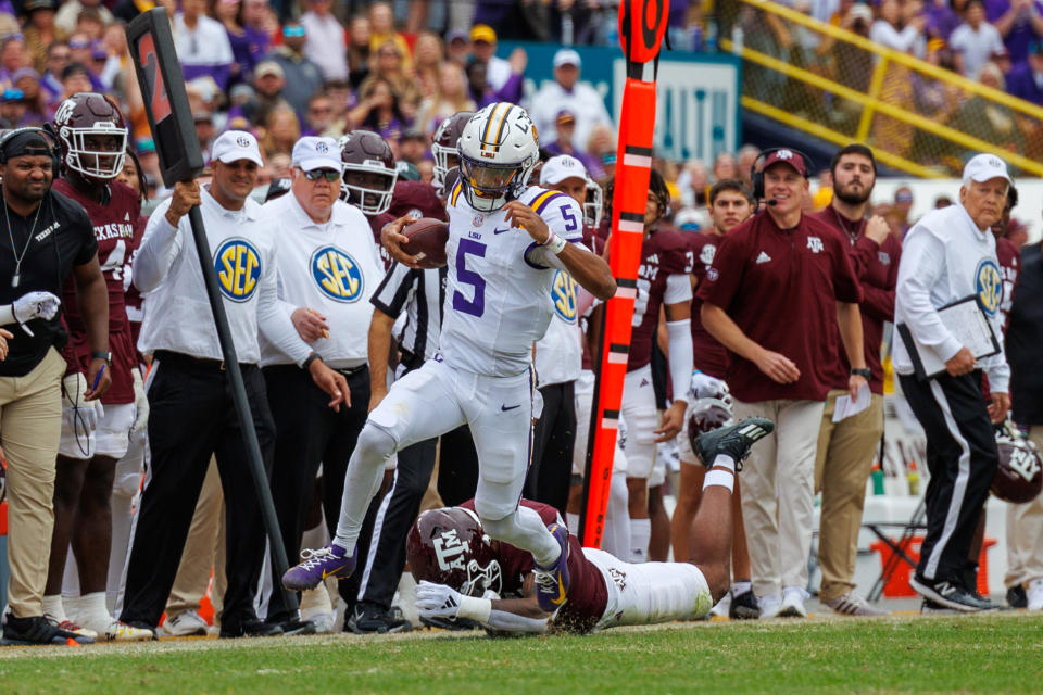 Nov 25, 2023; Baton Rouge, Louisiana, USA;  LSU Tigers quarterback Jayden Daniels (5) scrambles against the Texas A&M Aggies during the second half at Tiger Stadium. Mandatory Credit: Stephen Lew-USA TODAY Sports