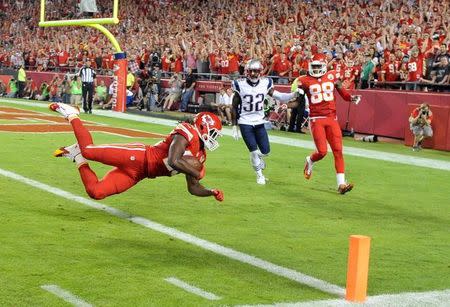 Sep 29, 2014; Kansas City, MO, USA; Kansas City Chiefs running back Jamaal Charles (25) dives in for a touchdown against the New England Patriots in the second half at Arrowhead Stadium. John Rieger-USA TODAY Sports