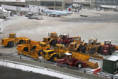 Snow removal equipment sits on the tarmac at Logan Airport in Boston, Massachusetts January 26, 2015. REUTERS/Brian Snyder