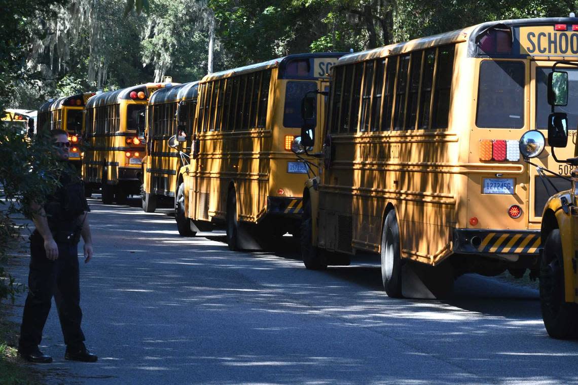 Buses line up along Youmans Drive to pick up students from Beaufort High School Wednesday after law enforcement received a hoax call about shots fired.