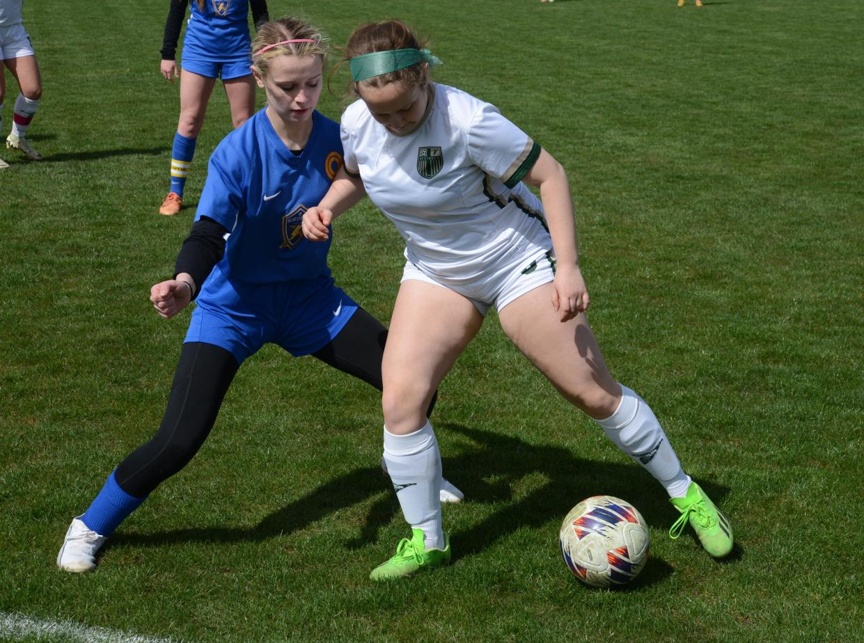 St. Mary Catholic Central’s Chloe Orris shields Reese Woelmer of Ida off the ball during the SMCC Invitational on Saturday, April 20, 2024.