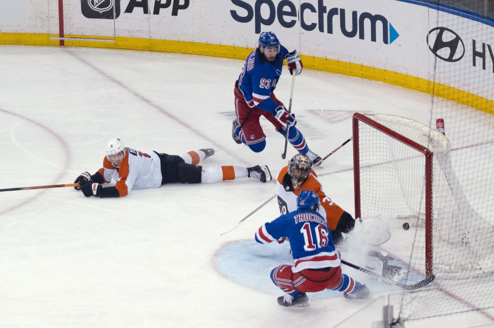 New York Rangers' Vincent Trocheck (16) scores against Philadelphia Flyers goaltender Samuel Ersson (33) during the third period of an NHL hockey game on Tuesday, March 26, 2024 in New York. (AP Photo/Peter K. Afriyie)