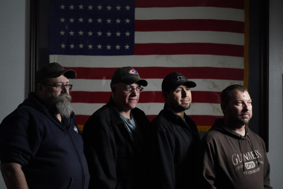 Workers from Craig Station, from left, Ron Geary, Gene LeFeure, Trinidad Loya and Wes Lytle of the International Brotherhood of Electrical Workers union pose for a photograph Wednesday, Nov. 17, 2021, in Craig, Colo. The union represents the bargaining unit at the Craig plant and nearly 4,200 members across Colorado and Wyoming. (AP Photo/Rick Bowmer)