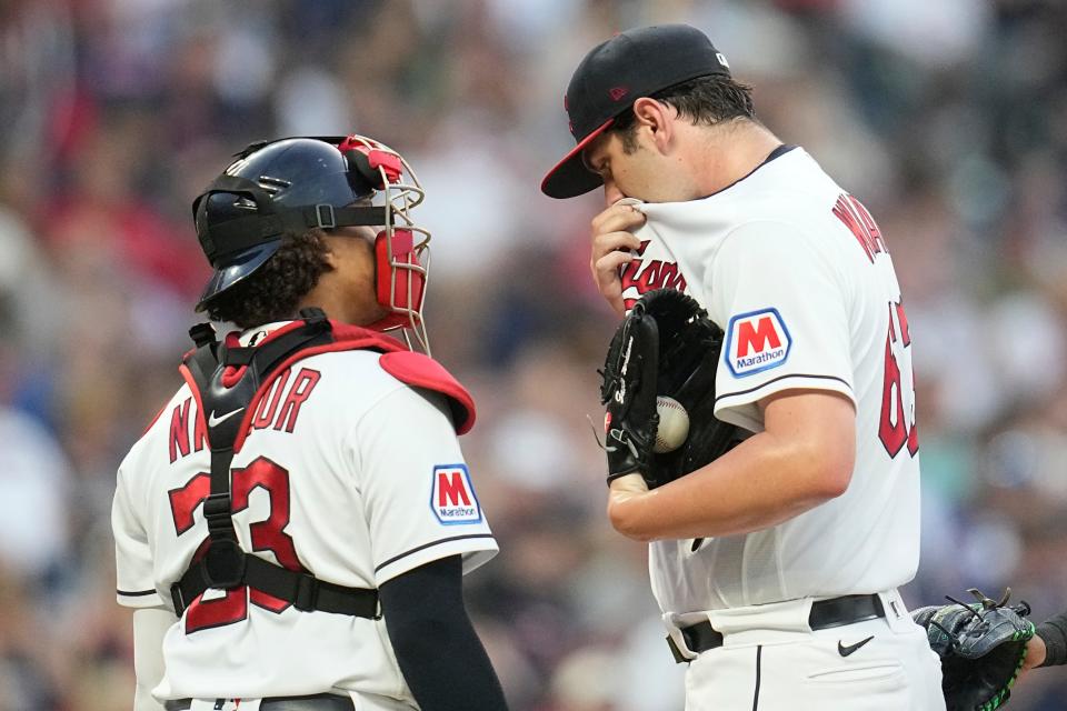 Cleveland Guardians catcher Josh Naylor, left, looks on as pitcher Gavin Williams wipes his face as he is taken out of a game against the Atlanta Braves July 3 in Cleveland.