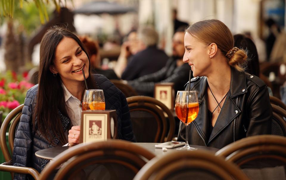 Two women talk while enjoying the afternoon at an outdoor cafe in Lviv Oblast in western Ukraine on Friday, May 5, 2023. | Scott G Winterton, Deseret News