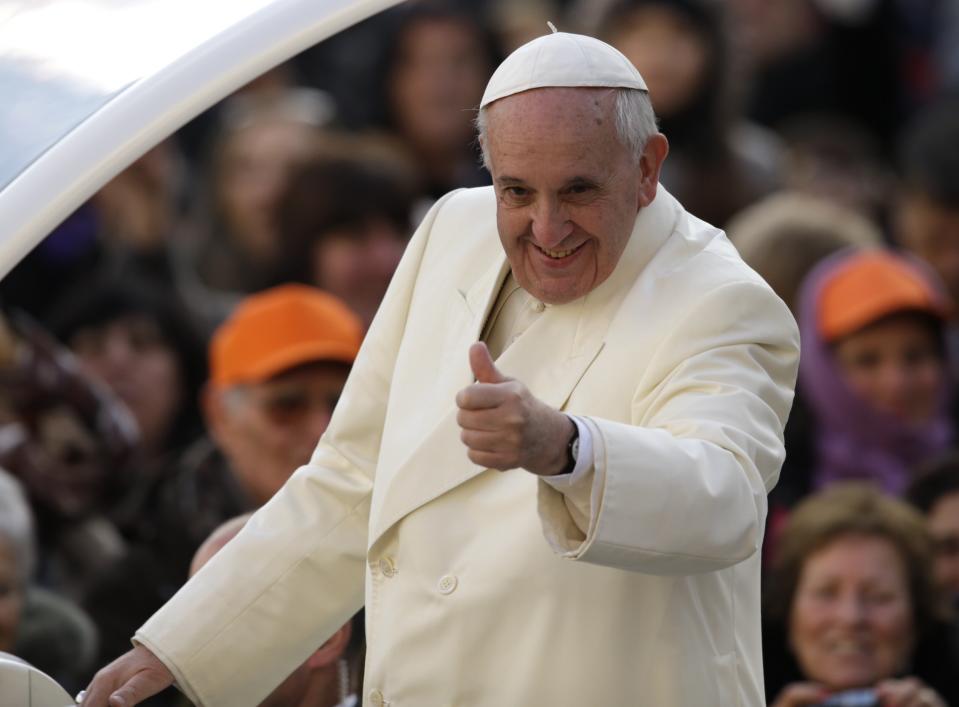 Pope Francis gives the thumbs as he arrives for his weekly general audience, in St. Peter's Square, at the Vatican, Wednesday, Jan. 15, 2014. (AP Photo/Andrew Medichini)