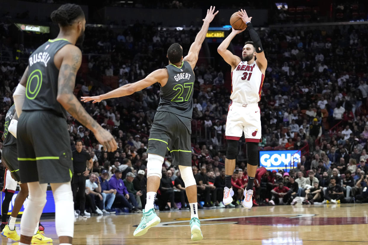 Miami Heat guard Max Strus (31) shoots as Minnesota Timberwolves center Rudy Gobert (27) defends during the second half of an NBA basketball game, Monday, Dec. 26, 2022, in Miami. The Heat won 113-110. (AP Photo/Lynne Sladky)