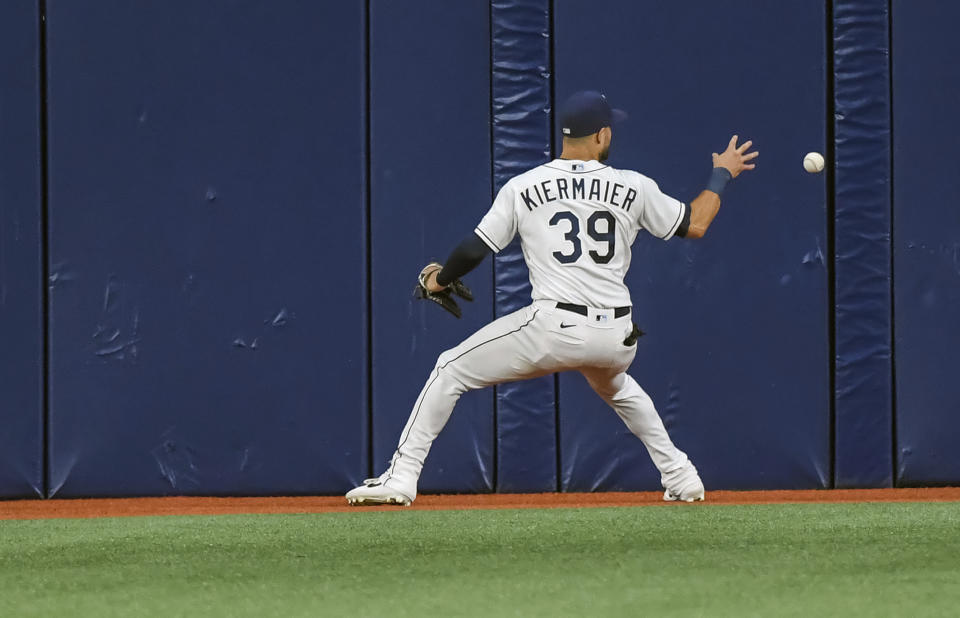 Tampa Bay Rays center fielder Kevin Kiermaier reaches for a line-drive single off the wall hit by New York Yankees' Gleyber Torres during the fourth inning of a baseball game Tuesday, July 27, 2021, in St. Petersburg, Fla. (AP Photo/Steve Nesius)