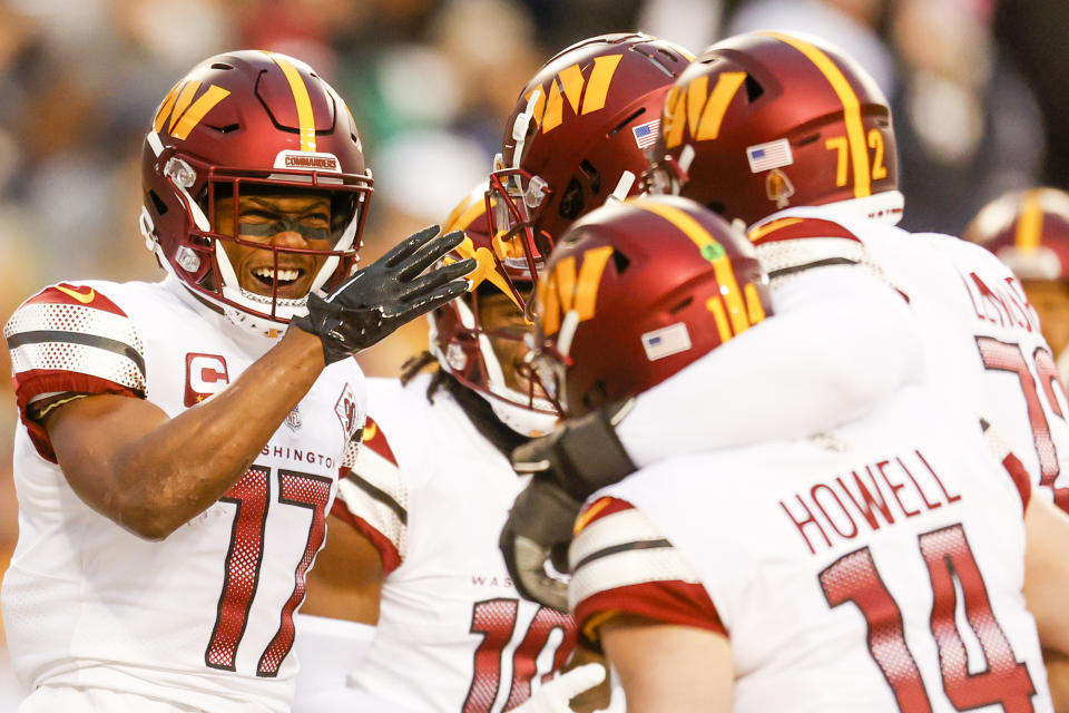 Washington Commanders wide receiver Terry McLaurin (17) celebrates his touchdown with quarterback Sam Howell (14) and other teammates during the first half of a NFL football game between the Dallas Cowboys and the Washington Commanders on Sunday, Jan. 8, 2023 at FedExField in Landover, Md. (Shaban Athuman/Richmond Times-Dispatch via AP)