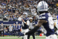Dallas Cowboys quarterback Dak Prescott (4) throws a touchdown pass to wide receiver CeeDee Lamb, front right, during the first half of an NFL football game against the Los Angeles Rams, Sunday, Oct. 29, 2023, in Arlington, Texas. (AP Photo/Michael Ainsworth)