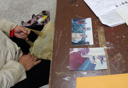 A woman attends a day of DNA collection next to photographs of missing family members in Sogamoso, Colombia, August 16, 2017. REUTERS/Julia Symmes Cobb