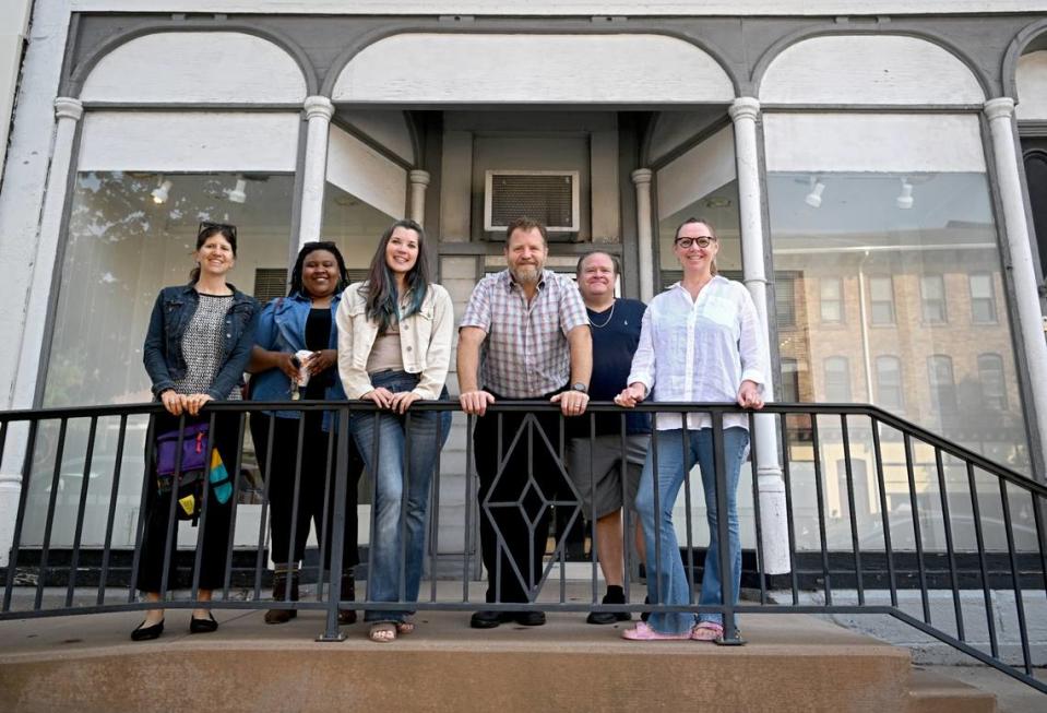 Community members including Ann Tarantino, Dara Walker, Melissa Stitzer, Jonathan Eburne, Scott Fry and Angie Bowman gather on the porch of 130 S. Allegheny St. in Bellefonte on Thursday, May 11, 2023. The space will become the home of the Print Factory.
