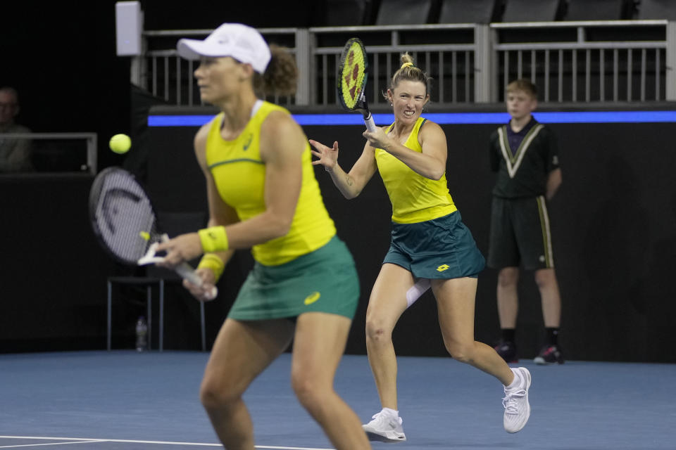 Storm Sanders, right, and Samantha Stosur of Australia return a ball during the semi-finals against Alicia Barnett and Olivia Nicholls of Great Britain, at the Billie Jean King Cup tennis finals at the Emirates Arena in Glasgow, Scotland, Saturday, Nov. 12, 2022. (AP Photo/Kin Cheung)