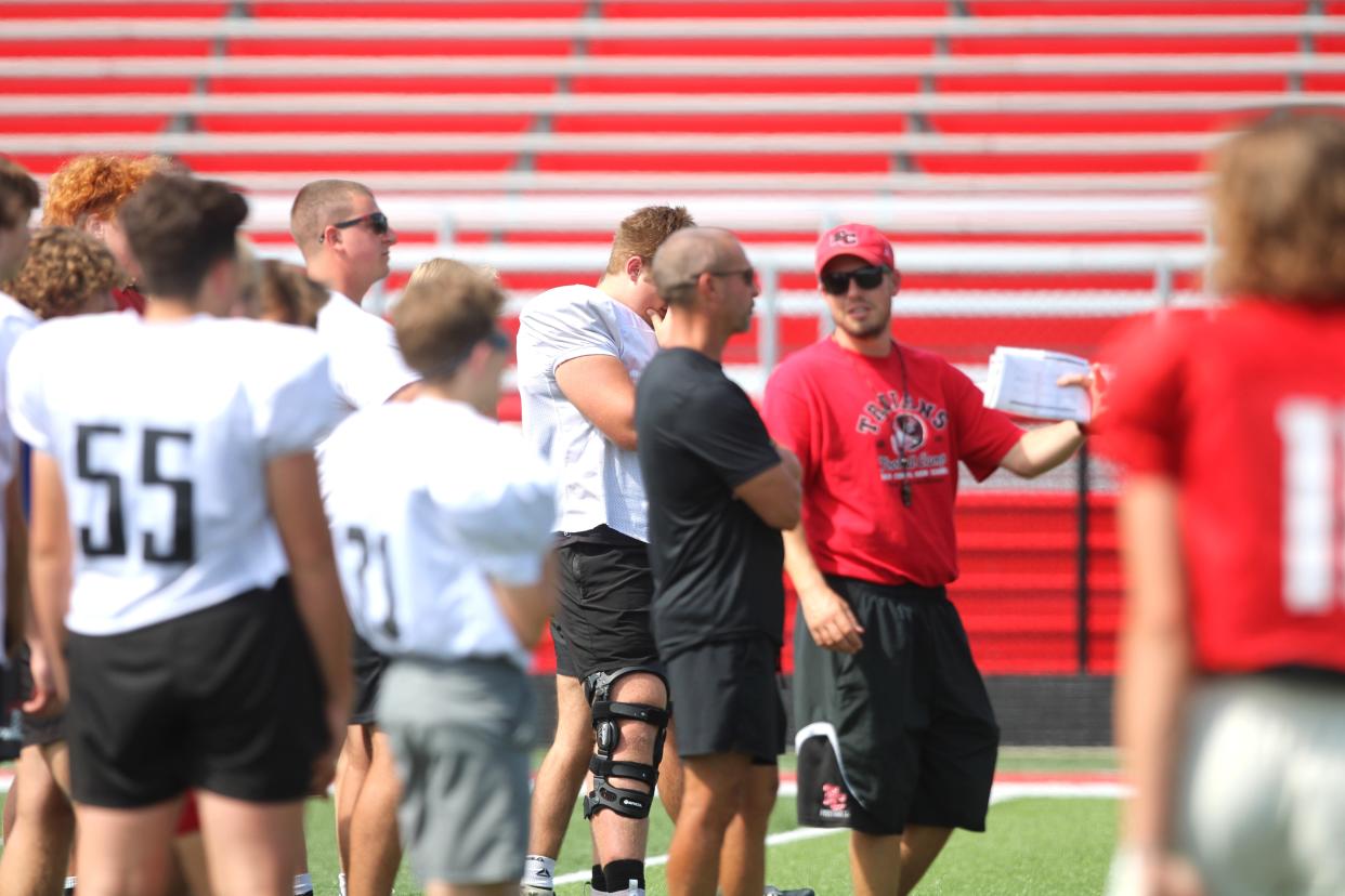 Head coach Jake Meiners talks to a player during East Central football practice in August 2024.