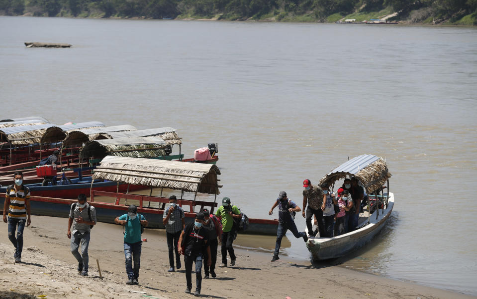 Migrants disembark on the Mexican side of the border after crossing the Usumacinta River from Guatemala, in Frontera Corozal, Chiapas state, Mexico, Wednesday, March 24, 2021. (AP Photo/Eduardo Verdugo)