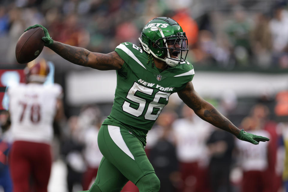 New York Jets linebacker Quincy Williams (56) reacts after intercepting a pass against the Washington Commanders during the third quarter of an NFL football game, Sunday, Dec. 24, 2023, in East Rutherford, N.J. (AP Photo/Adam Hunger)