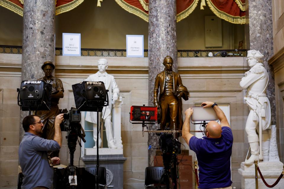 Journalists set up equipment for TV networks in Statuary Hall in the U.S. Capitol ahead of President Joe Biden's State of the Union address to Congress.