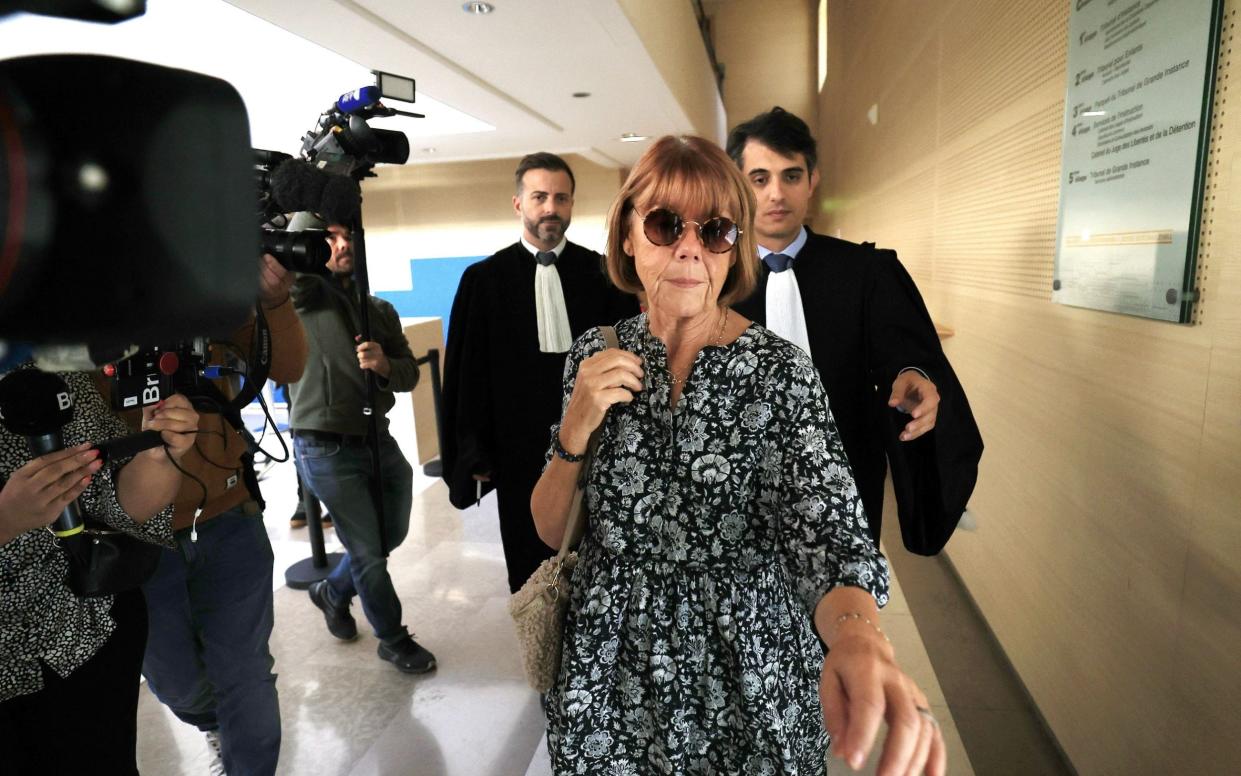 Mrs Pélicot ignores the cameras outside the court room