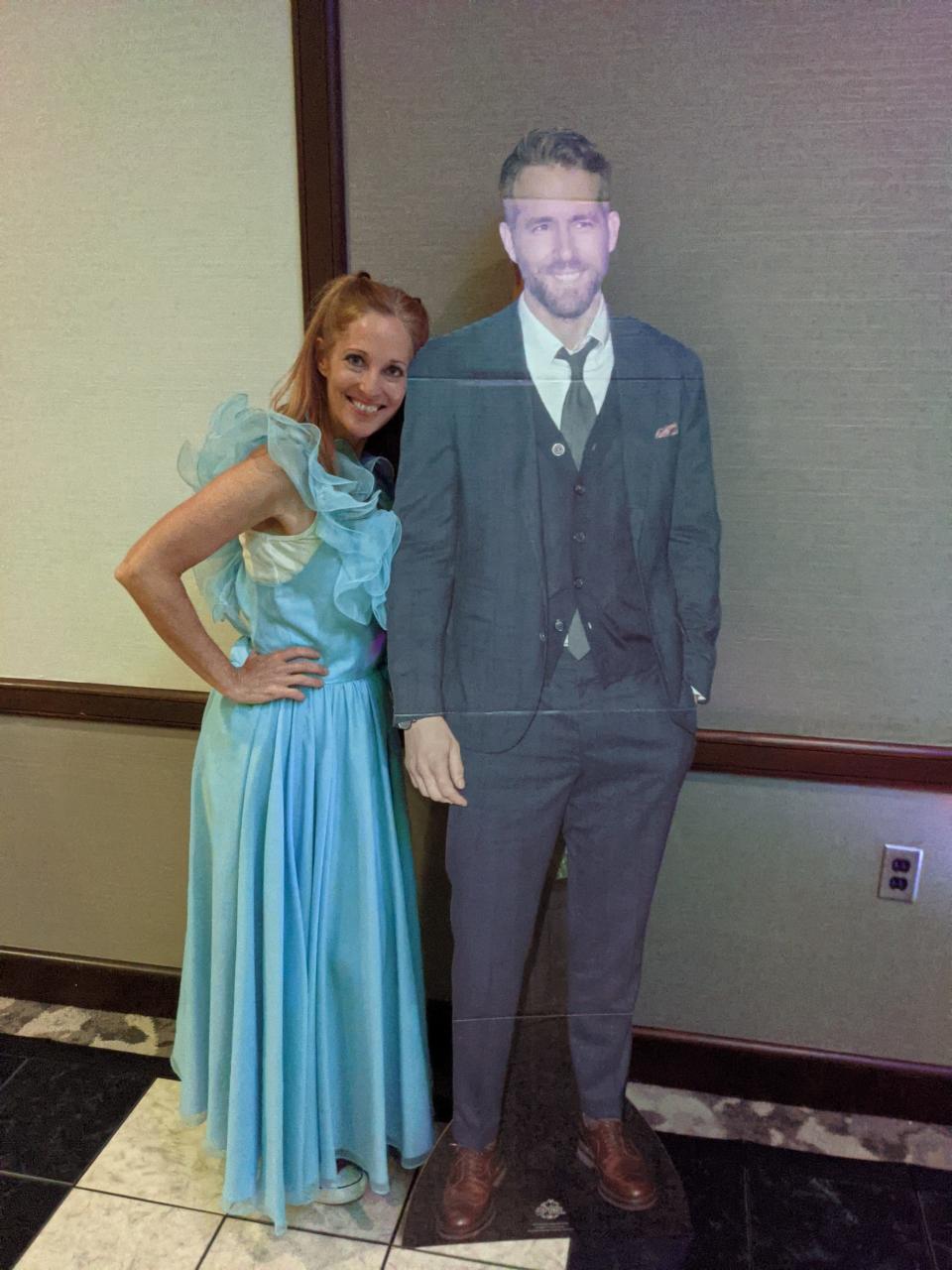 Betsy Crapps of South Lyon, in her prom dress at age 53 with a cutout of a movie star. Crapps is the founder of Mom Prom, now a nationwide charity movement in which women get together in their old prom or bridesmaid dresses to dance and raise money for charity. 