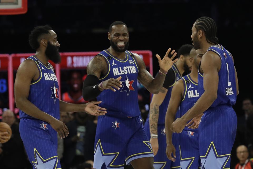 LeBron James of the Los Angeles Lakers celebrates with James Harden of the Houston Rockets and Kawhi Leonard of the Los Angeles Clippers during the second half of the NBA All-Star basketball game Sunday, Feb. 16, 2020, in Chicago. (AP Photo/Nam Huh)