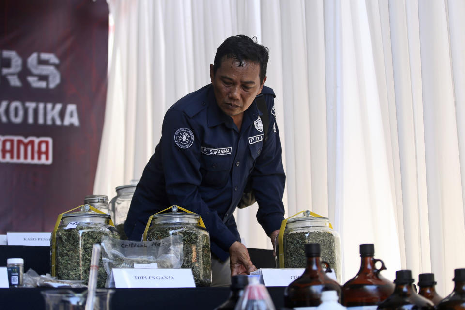 A police officer displays evidence during a news conference at a villa in Canggu, Bali, Indonesia on Monday, May 13, 2024. Indonesian police raided what they said was a major drug lab hidden in a villa on the resort island of Bali, and arrested four people. (AP Photo/Firdia Lisnawati)