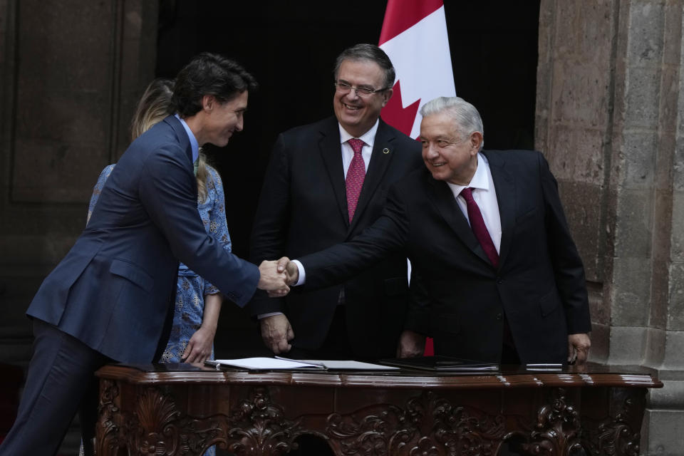 Canadian Prime Minister Justin Trudeau, left, shakes hands with Mexican President Andres Manuel Lopez Obrador during an agreement signing ceremony at the National Palace in Mexico City, Wednesday, Jan. 11, 2023. Behind are Mexican and Canadian Foreign Ministers Marcelo Ebrard and Melanie Joly. (AP Photo/Fernando Llano)