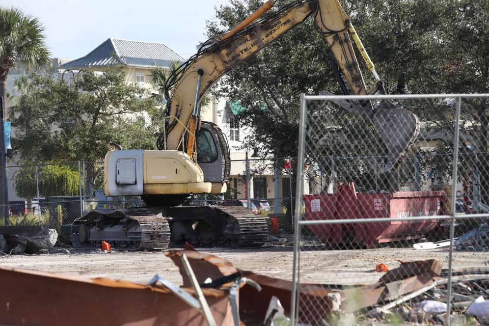 A demolition crew picks out metal to be recycled from the demolished remains of the Chuck E. Cheese restaurant/arcade that was destroyed during Tropical Storm Ian on Monday, Oct. 31, 2022.