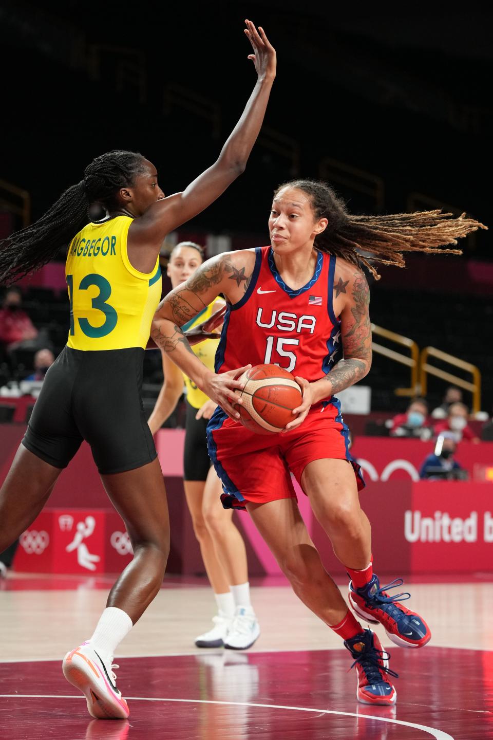 Brittney Griner (15) drives to the basket while being defended by Australia's Ezi Magbegor.