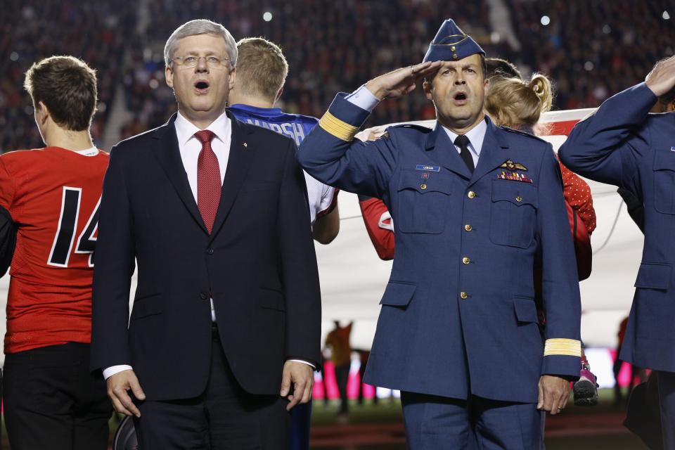 Canada's PM Harper and Canada's CDS Gen. Lawson take part in a tribute to recently fallen soldiers, prior to an Ottawa Redblacks CFL football game in Ottawa