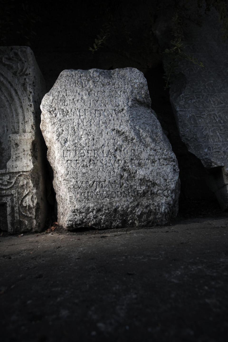 This Friday, Oct. 5, 2012 photo shows ancient Roman inscription on tombstone, found on the site of Ratiaria, an ancient Roman settlement located on the banks of the Danube, in the northwest corner of Bulgaria. Located on the crossroads of many ancient civilizations, Bulgarian scholars rank their country behind only Italy and Greece in Europe for the numbers of antiquities lying in its soil. But Bulgaria has been powerless to prevent the rape of its ancient sites, depriving the world of part of its cultural legacy and also costing this impoverished Balkan nation much-needed tourism revenue. (AP Photo/Valentina Petrova)