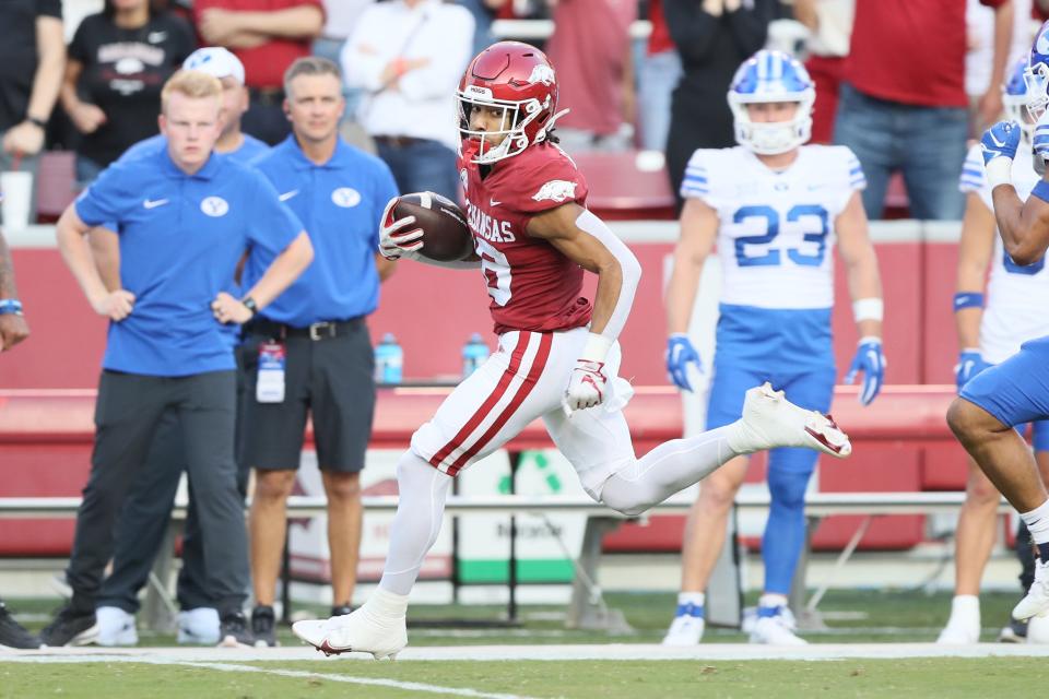 Sep 16, 2023; Fayetteville, Arkansas, USA; Arkansas Razorbacks wide receiver Isaiah Sating (16) returns a punt for a touchdown in the first quarter against the BYU Cougars at Donald W. Reynolds Razorback Stadium.