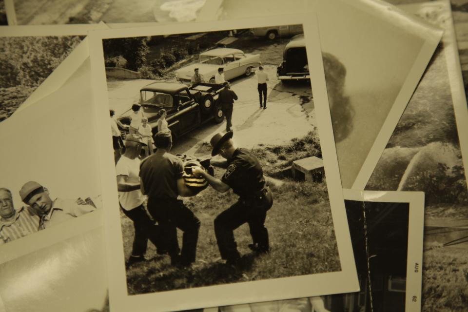 Officials carry her torso from a lake.