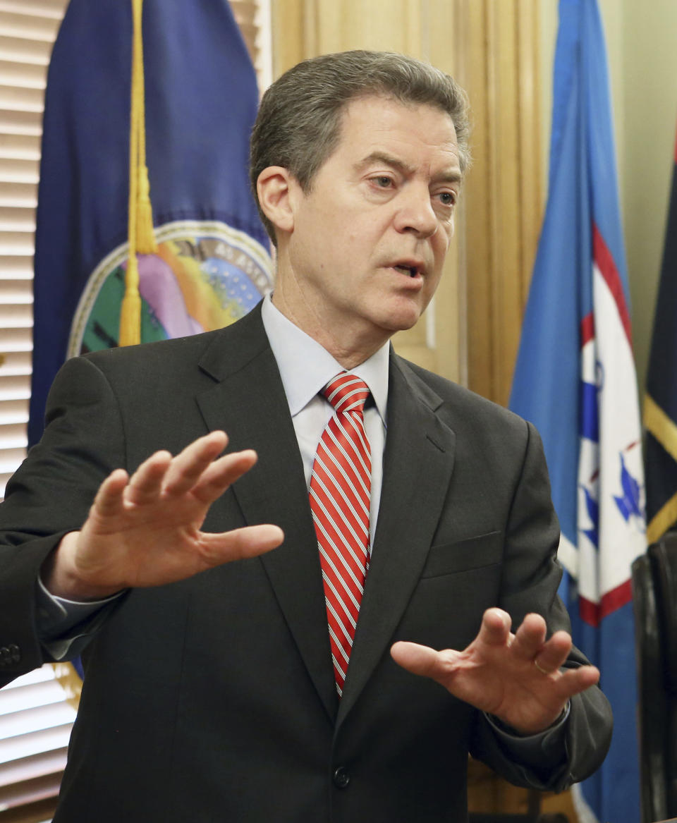 Gov. Sam Brownback takes questions from the media after signing the veto of the tax bill sent to him from the legislature, Wednesday, Feb. 22, 2017. (Thad Allton /The Topeka Capital-Journal via AP)